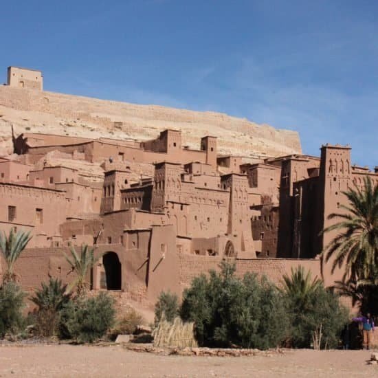The mud-brick ksar of Ait Ben Haddou with palm trees