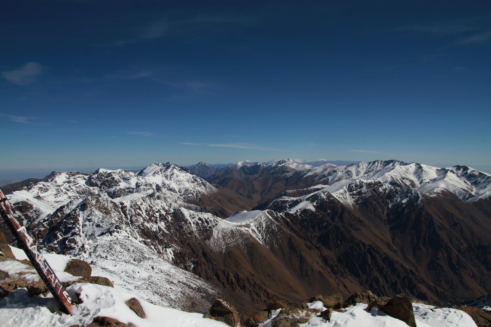 View over snow-streaked High Atlas ridges from a summit