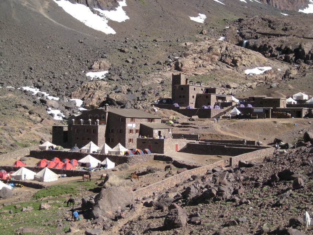 The Toubkal Refuge buildings with tents pitched outside