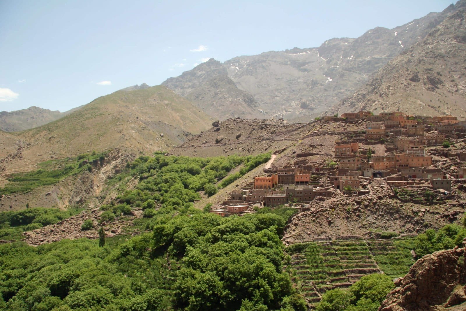 Berber village above green terraces and trees in a High Atlas valley