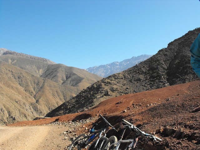Mountain bikes resting beside a red-earth track in the Atlas Mountains